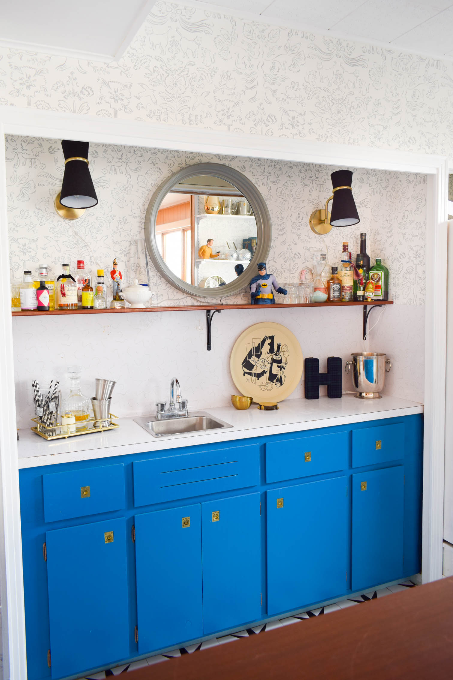 Our basement bar was a nightmare from the 70s, and now it's a clean modern space. With a few budget friendly updates we took it from drab to fab. Freshly painted cabinets, peel and stick floor tiles, and new wallpaper are just what the space needed!