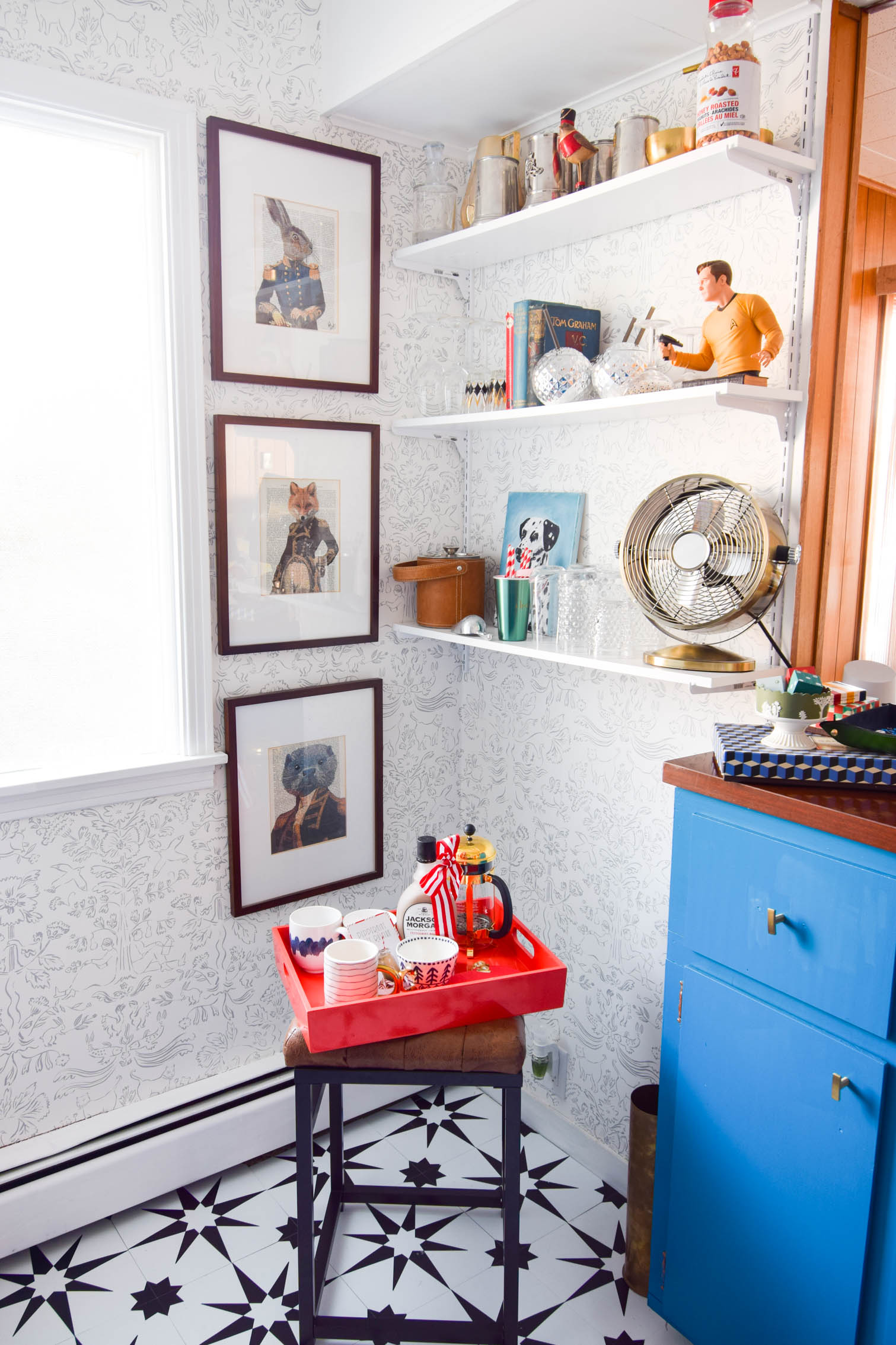 Our basement bar was a nightmare from the 70s, and now it's a clean modern space. With a few budget friendly updates we took it from drab to fab. Freshly painted cabinets, peel and stick floor tiles, and new wallpaper are just what the space needed!