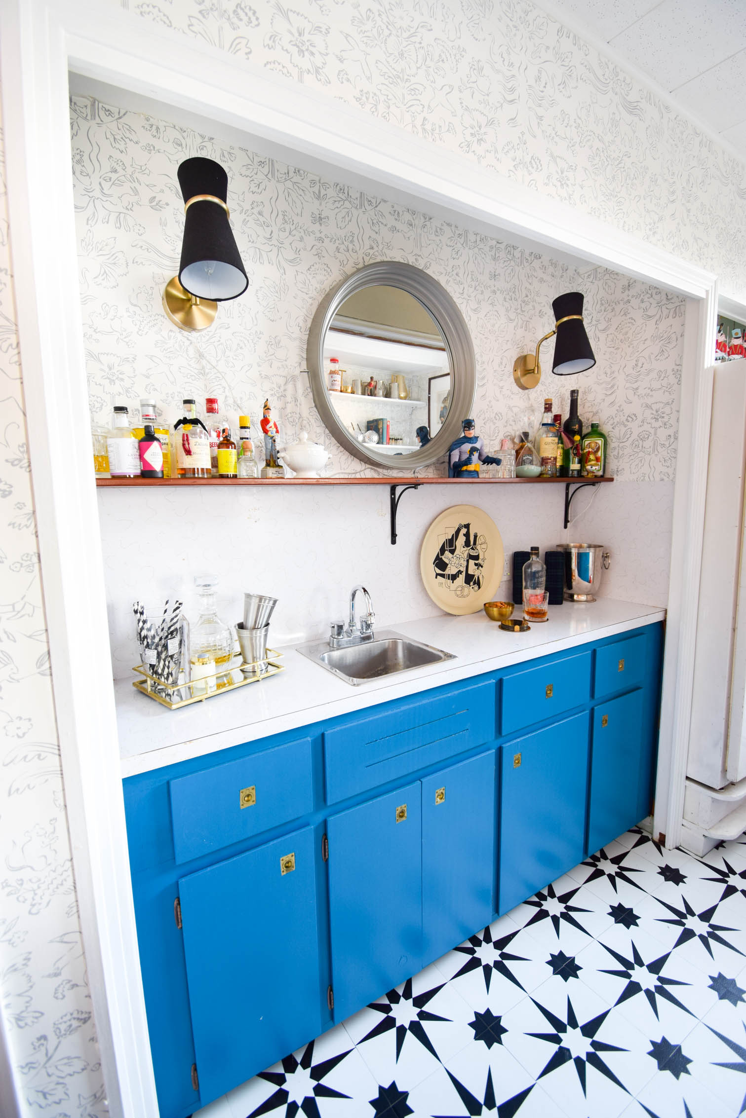 Our basement bar was a nightmare from the 70s, and now it's a clean modern space. With a few budget friendly updates we took it from drab to fab. Freshly painted cabinets, peel and stick floor tiles, and new wallpaper are just what the space needed!