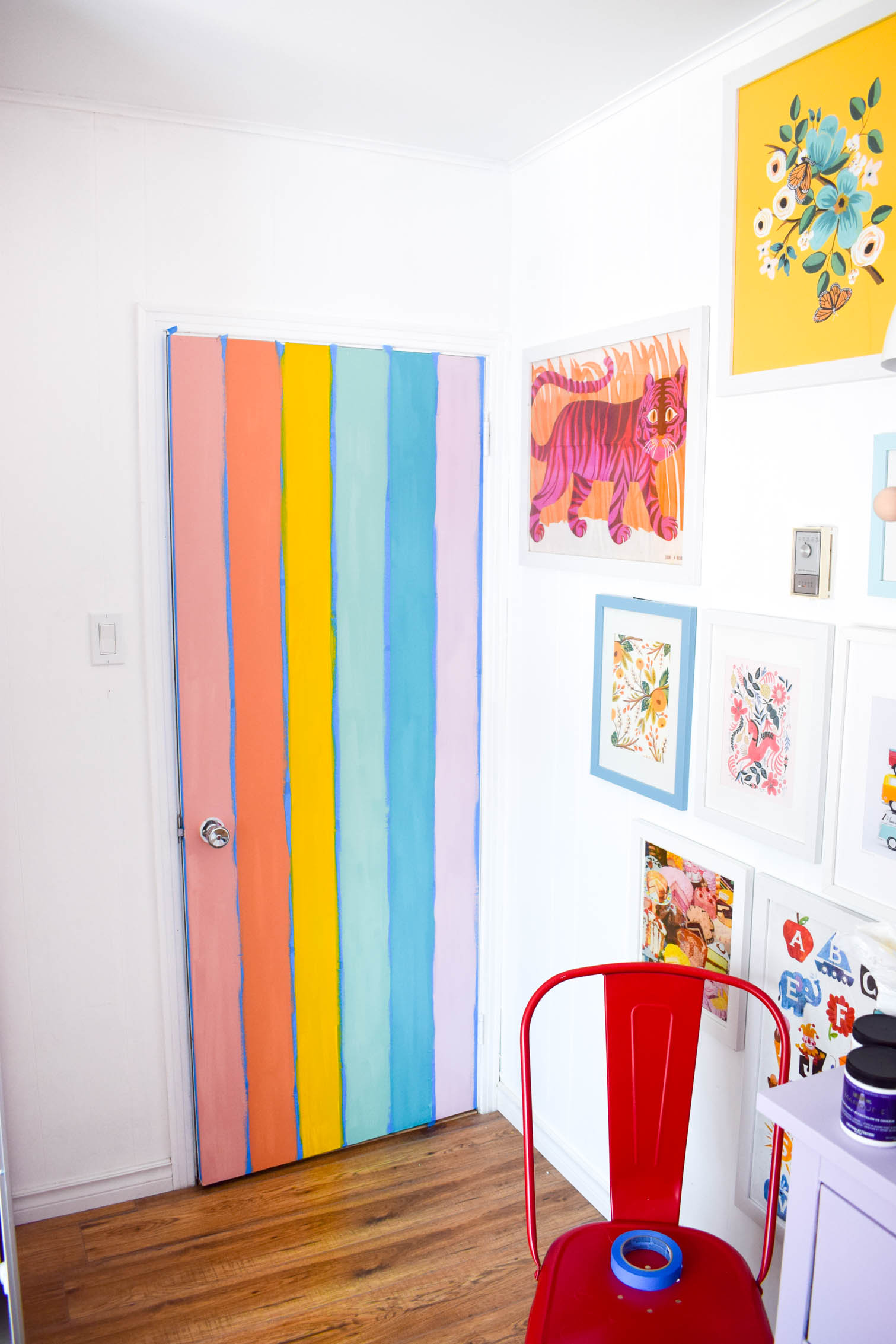 A DIY rainbow nursery door is how you nail two trends in one project! Get rainbows and murals all in one, and add a major pop of color to any space.
