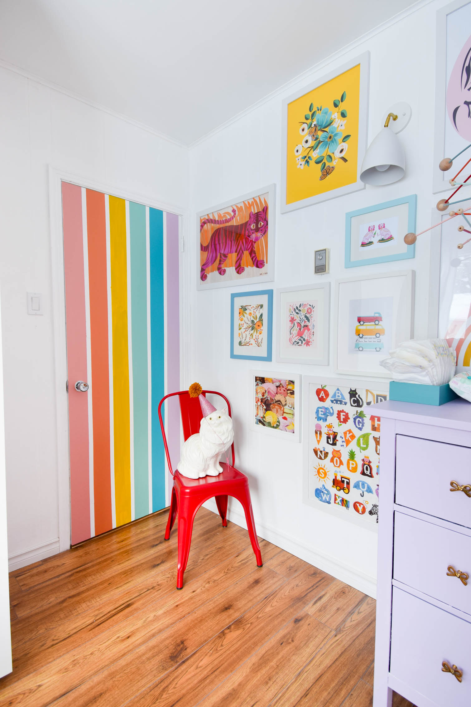 A DIY rainbow nursery door is how you nail two trends in one project! Get rainbows and murals all in one, and add a major pop of color to any space. A DIY rainbow nursery door is how you nail two trends in one project! Get rainbows and murals all in one, and add a major pop of color to any space.