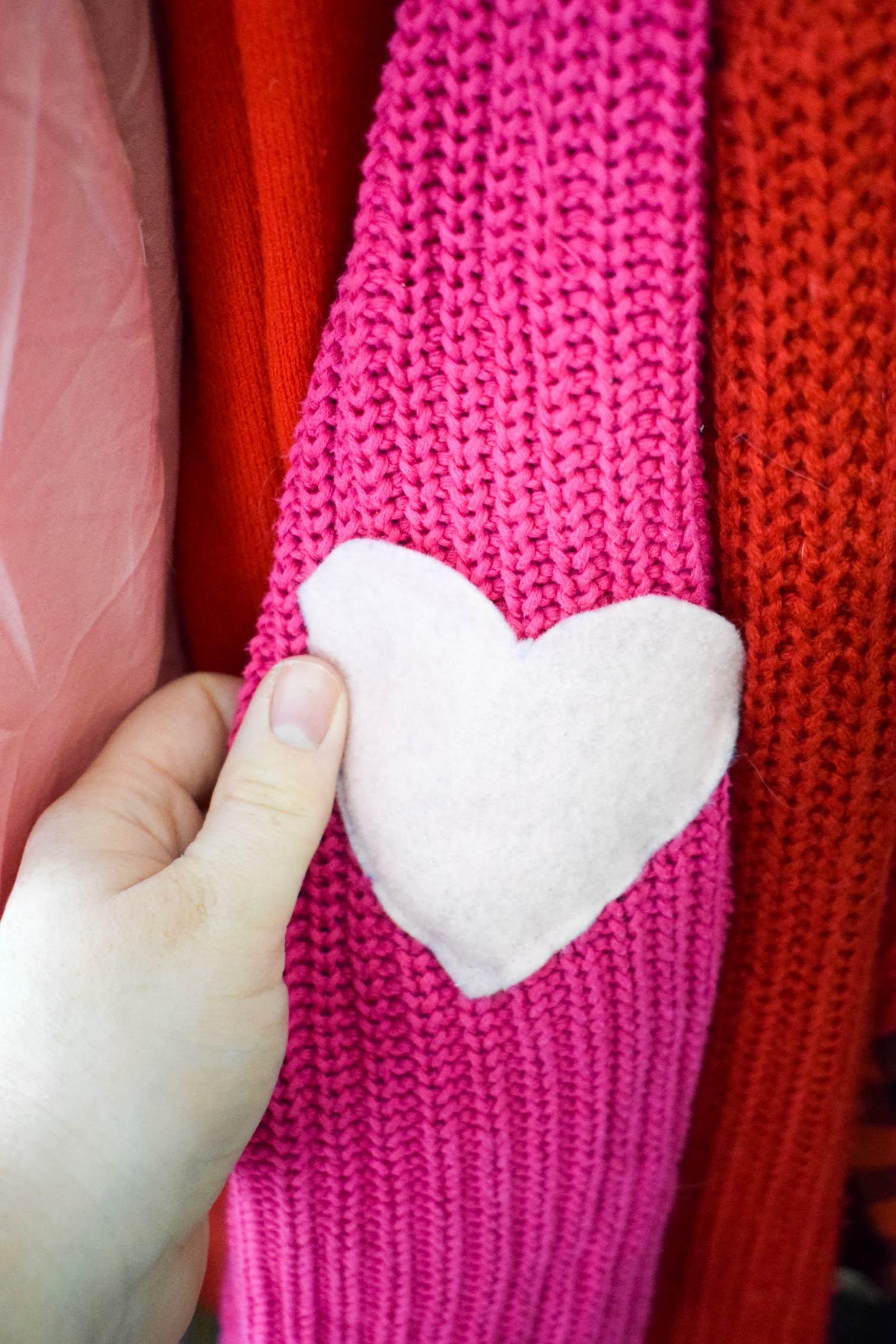 DIY Heart elbow patches are the easiest way to refashion a sweater. Using felt and a needle + thread, you can add adorable style in a few minutes to any top