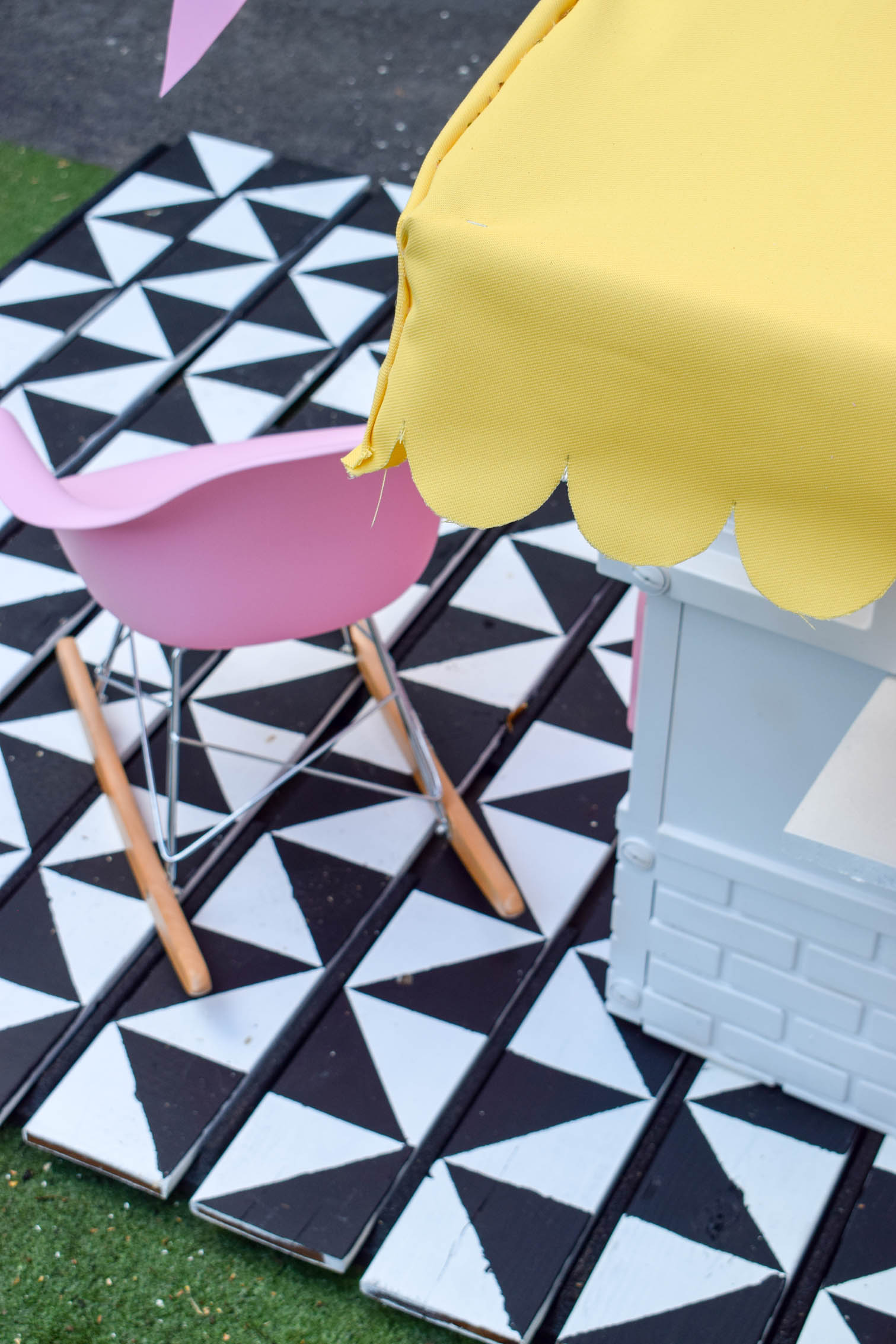I completed a Mid Century Playhouse Makeover with a floating deck, painted to look like tiles. Easy! Come grab the tutorial and see the pics.