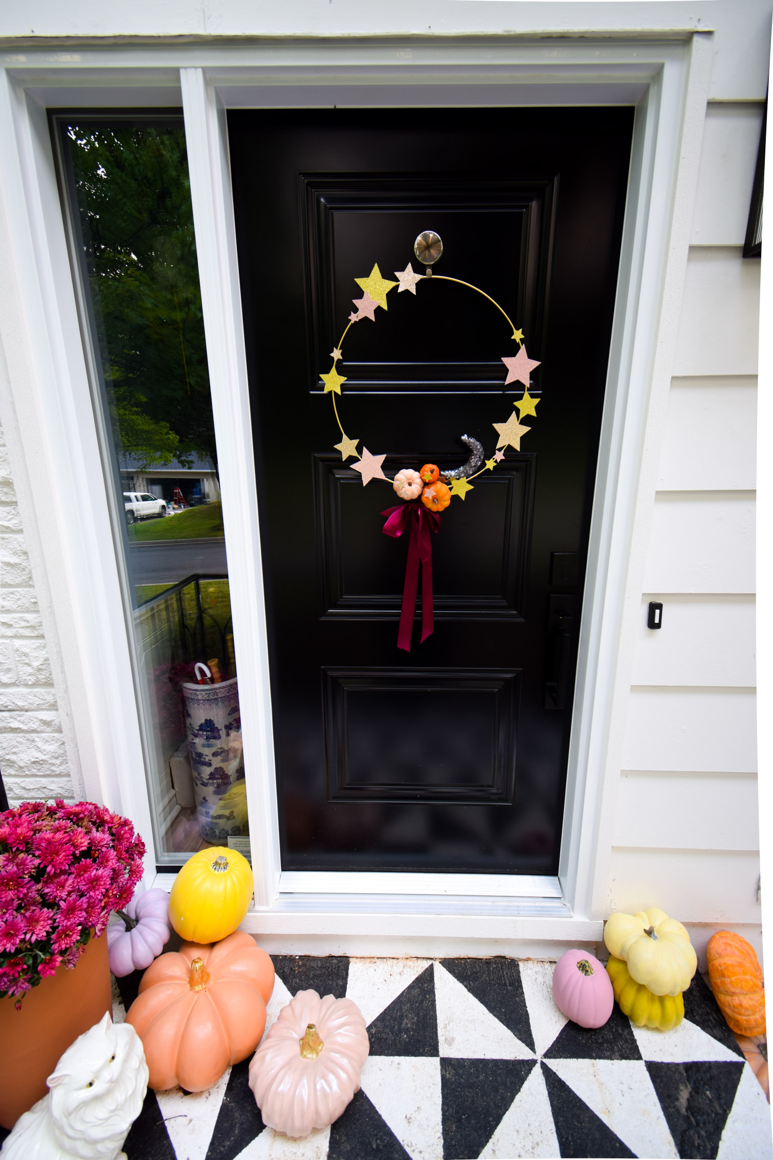 Using glitter cardstock and craft pumpkins, create a star and pumpkin fall wreath. A hoop wreath for your front door, and one for the playhouse too!