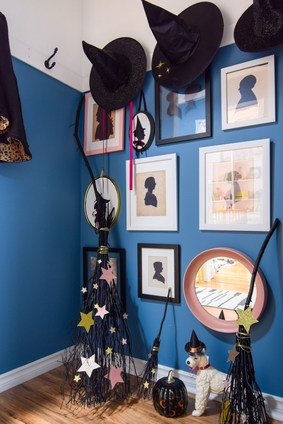 Turn your entryway into a spooky and glam witch broom closet. One that any witch would be pleased to hang her cloak in.