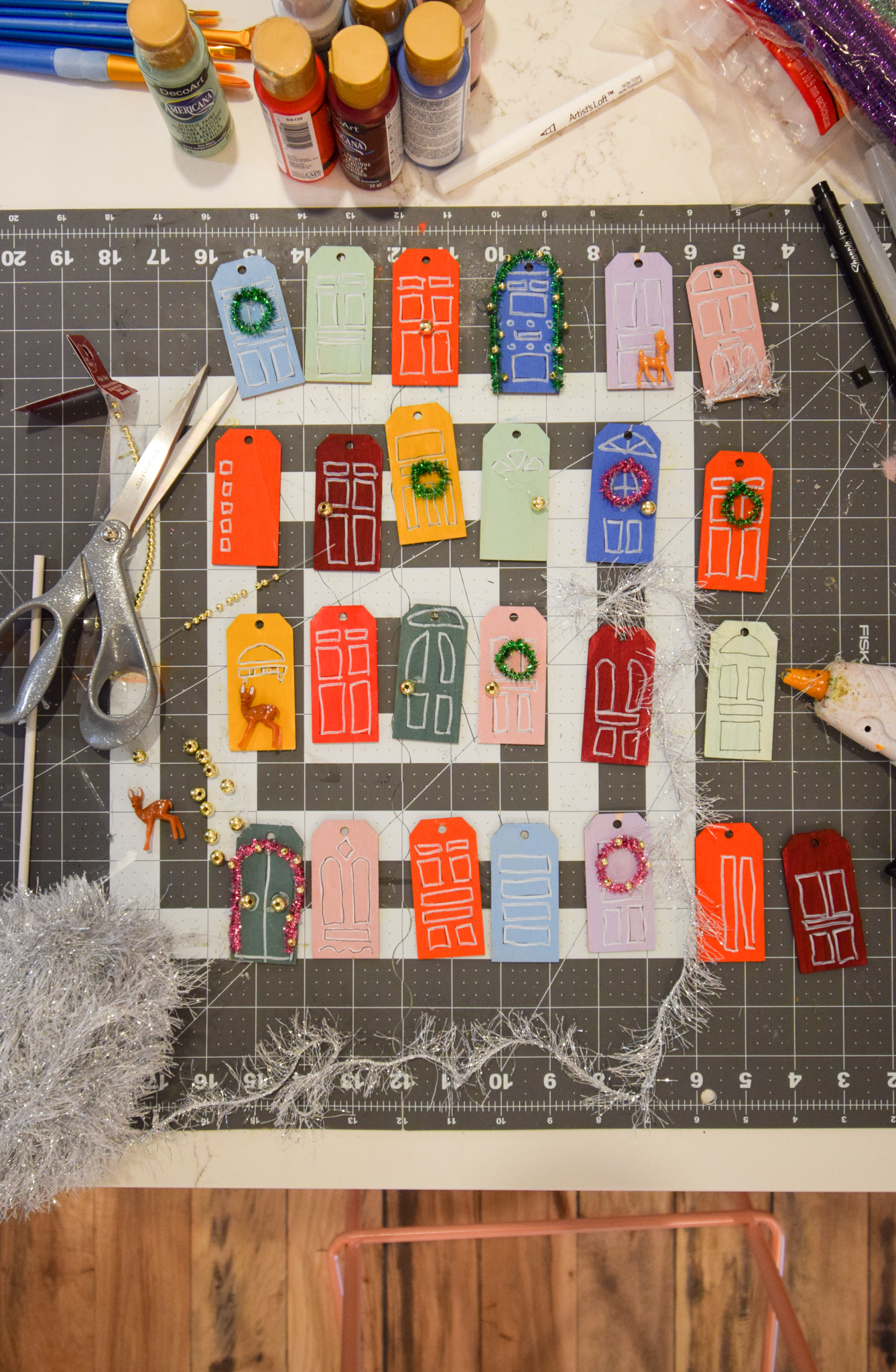 make a fun DIY reusable advent calendar that looks like all the fun and festive snow covered doors in your city or neighbourhood.